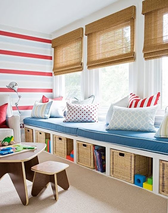 a window bench with cushions, wicker boxes and storage is a very inviting space to read or just dream