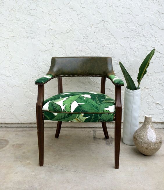 reupholster a usual chair with banana leaf printed fabric to give it a tropical feel