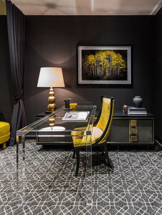 a moody home office with bold yellow touches and a durable and stable clear glass desk that seems to be disappearing