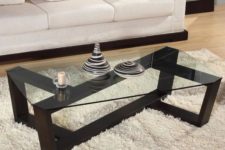 30 ultra-modern coffee table with a sculptural dark stained wooden base and a glass tabletop