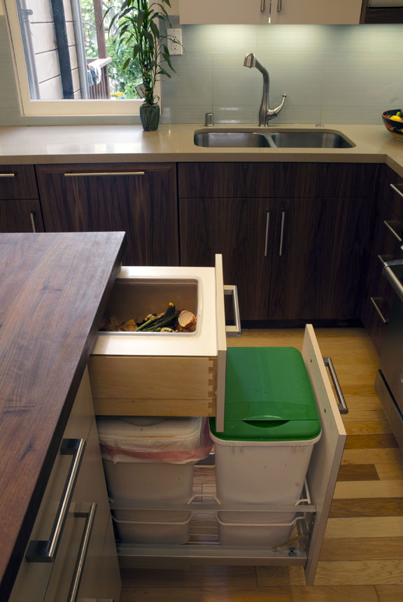 small trash cans could allow your cabinet to fit an additional drawer