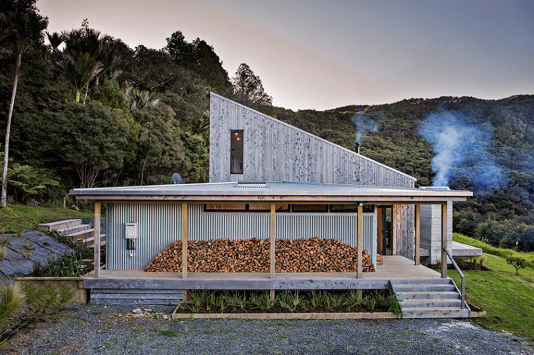 An adjoining annex contains additional bedrooms and service areas, and outside you can see firewood storage