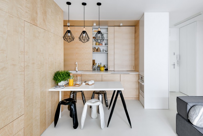 The kitchen is cla with wood panels like the most of the space, panels look sleek and modern