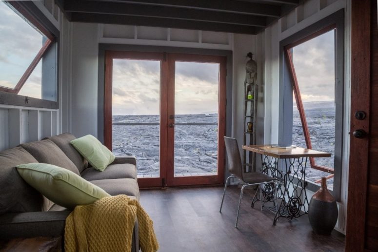 glass doors to enjoy vies There are many windows and glass doors to enjoy the unique views and lava, there's a working space with a vintage desk at the window and a large sofa to have a look outdoors