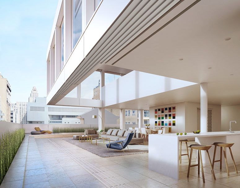 There are walls that can open the duplex to outdoors, the outdoor space features green grass, an eating space with a countertop and a cozy living space