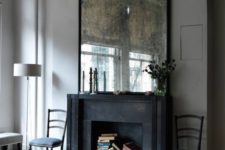 02 a black fireplace is repurposed into a book storage space