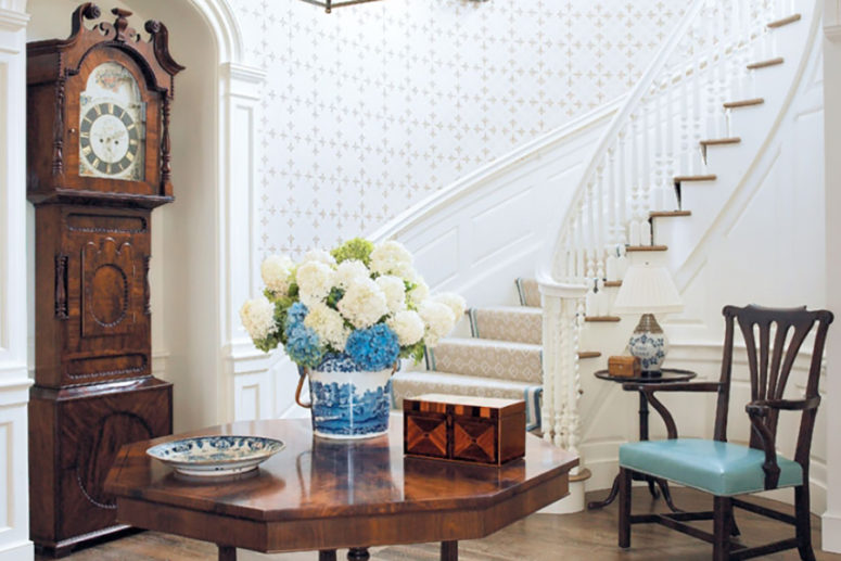 a vintage polished wood grandfather's clock perfectly fits a traditional hallway and matches the furniture