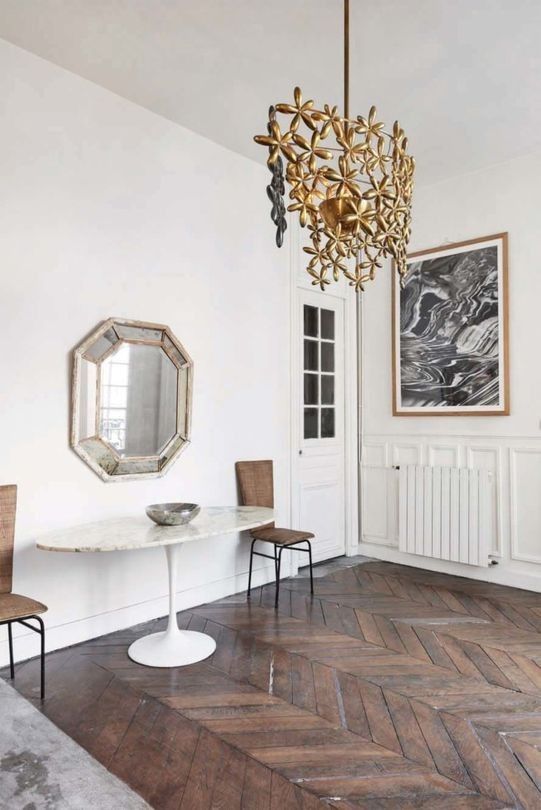 glam flower inspired chandelier The home is filled with interesting items like this floral chandelier, a vintage mirror and many artworks