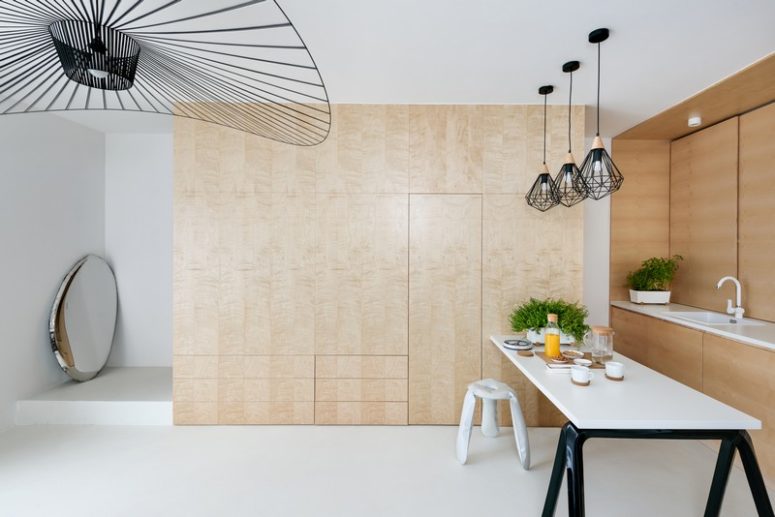 There's a pantry under the staircase, which is hidden behind a sleek door and there are also some drawers