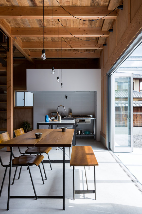 This level is opened to outdoors with a foldable glazed wall and the hanging bulbs are accentuate the space This level is opened to outdoors with a foldable glazed wall and the hanging bulbs are accentuate the space
