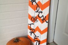 04 an orange and white chevron sign with black letters and a burlap bow