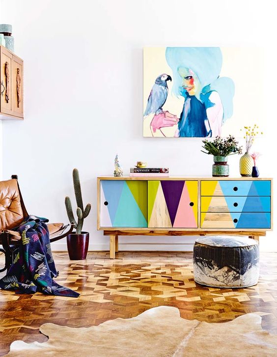 bold geometric sideboard and a matching watercolor wall art stand out in a neutral interior