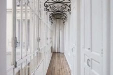 05 The corridor filled with light through the glazed wall is accentuated with forged vignettes on the ceiling