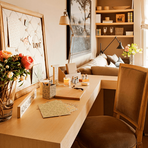 The home office is cute and cozy, with a pinboard and comfy chair