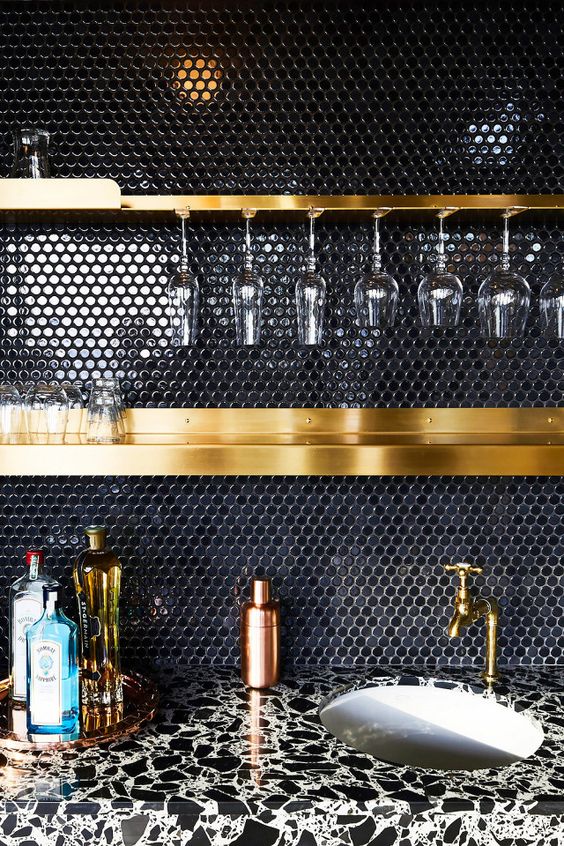 glossy black penny tiles for a chic kitchen backsplash, brass glass holders and shelves