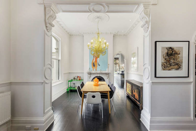 Here's a dining room with modern dinign furniture, an antique sideboard and a modern and bold chandelier Here's a dining room with modern dinign furniture, an antique sideboard and a modern and bold chandelier