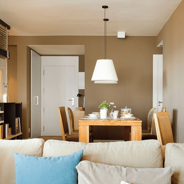 The dining space features a wooden dining set and some pendant lamps