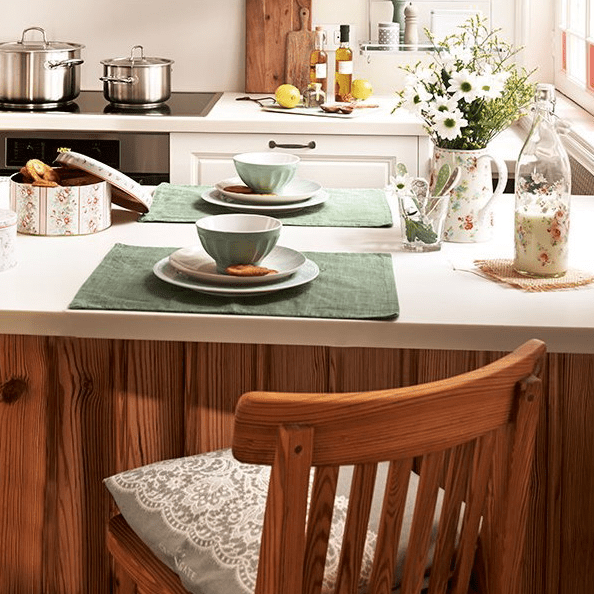 The kitchen island doubles as a dining space and a storage piece