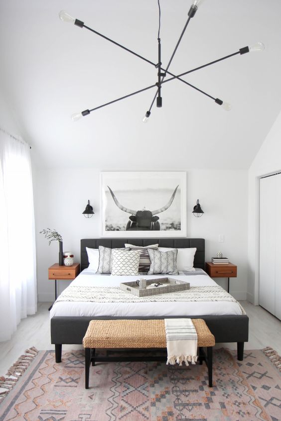 a modern black chandelier and small black sconces for a stylish modern bedroom