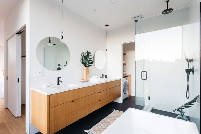 The bathroom is rather large, with a double vanity and a laundry space