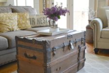 08 a tall chest with blackened iron as a coffee table and a storage piece