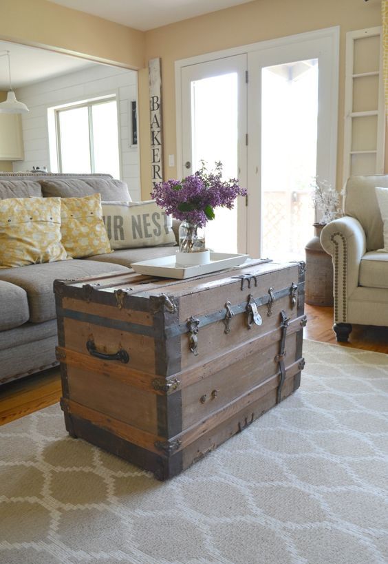 a tall chest with blackened iron as a coffee table and a storage piece