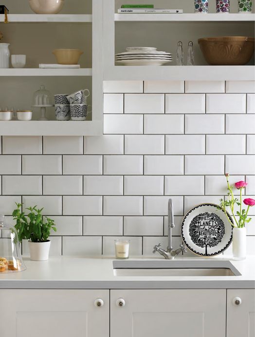 subway tiles with dark grout for definition and open cabinets are a fresh take on a traditional white kitchen
