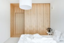 09 The storage is represented with textural wood panels without any handles