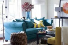 09 a bold blue sofa and a sunny yellow chair and pillows for a gorgeous coastal room
