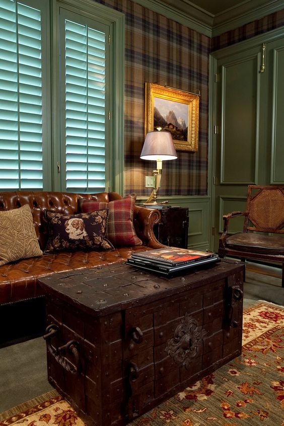 a dark-colored vintage chest as a coffee table for a traditional and masculine living room