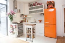 09 a neutral modern kitchen with a bold orange Smeg fridge for a colorful statement