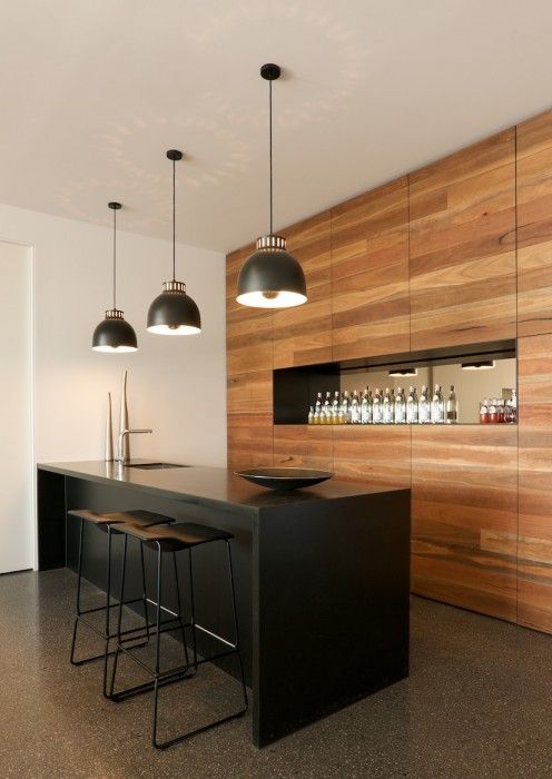 a black kitchen island doubles as a kitchen countertop, and it stands out in decor