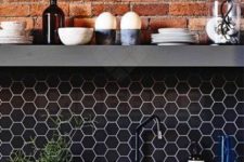 10 an industrial kitchen with a brick wall, a navy hex tile backsplash and navy countertops