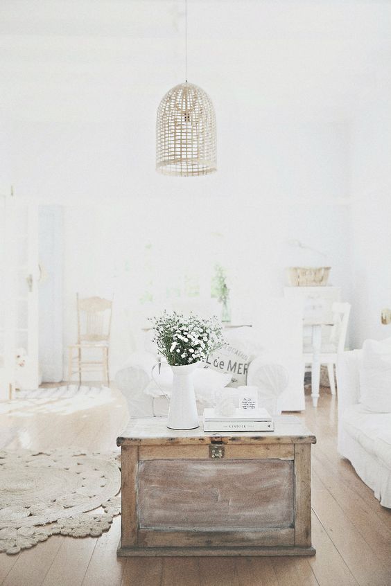 a shabby chic neutral room with a wooden chest as a coffee table - wood texture adds coziness