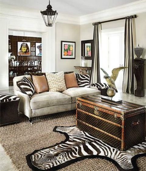 African flavor room with a large dark vintage chest as a coffee table - feel the adventure spirit