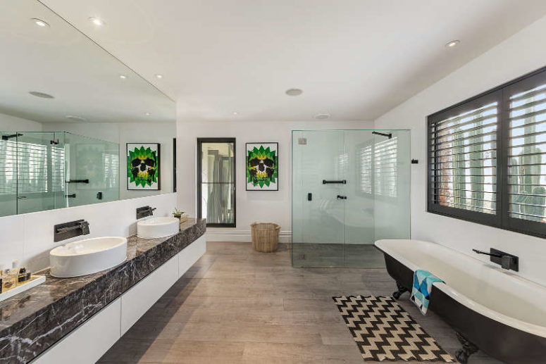 The master bathroom is large, there's a shower, a vintage bathtub and a double bathroom vanit of marble The master bathroom is large, there's a shower, a vintage bathtub and a double bathroom vanit of marble