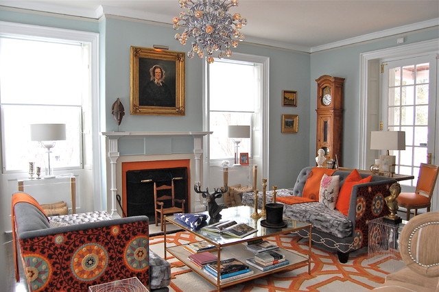 a colorful modern living room with a touch of vintage - aclock in the corner, a fireplace, an antique portrait