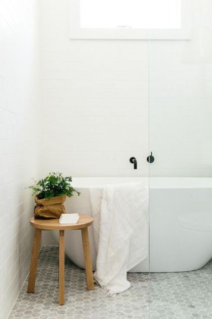 marble hex tiles on the floor and matte white ones on the walls for a peaceful bathroom