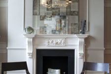 14 a white vintage fireplace with black inside and firewood on a metal stand just for display