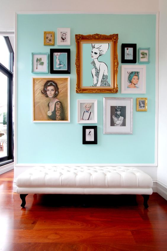 a refined entryway with a mint colored statement wall and a gallery wall looks refreshing