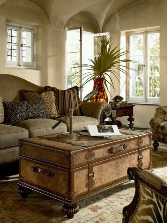 a refined wooden chest placed on legs to turn it into a real coffee table