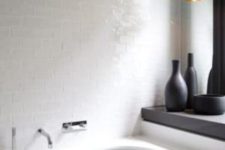 16 a minimalist bathroom was added a textural touch with glossy white tiles and a matte black pendant lamp