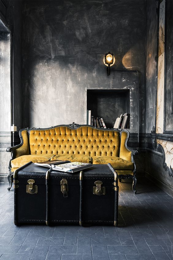 a refined living room highlighted with a large black vintage trunk as a coffee table