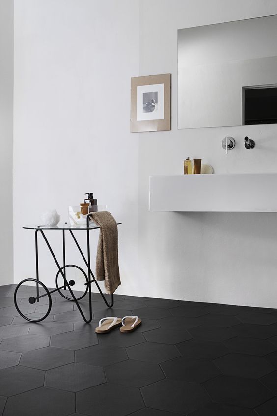 matte black hexagon tiles cover the bathroom floor to highlight the flawless minimalist style