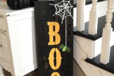 17 a black pallet sign with BOO letters, a web and a spider is easy to make