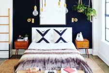 18 a chic boho-inspired bedroom with a navy statement wall and brass touches