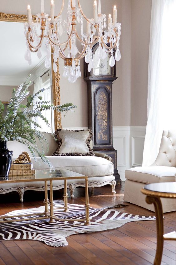 a luxurious interior with a grandfather's clock, a refined sofa and an animal print-inspired rug