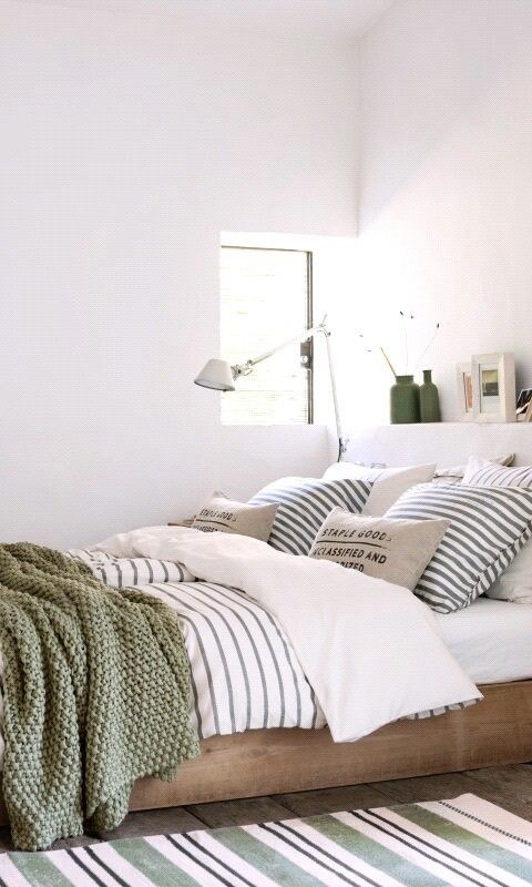 comfortable bedding of natural fabrics and an additional crochet blanket