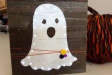 18 mini pallet sign with a lit up ghost, colorful yarn and buttons