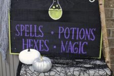 19 a black pallet sign with purple and white letters and a fun potion bottle